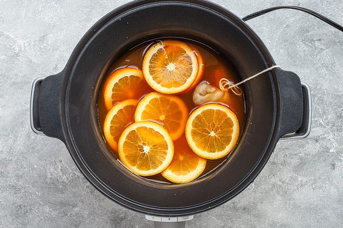 Spiced cider in the slow cooker with orange slices and a spice bag, from Taste of Home.