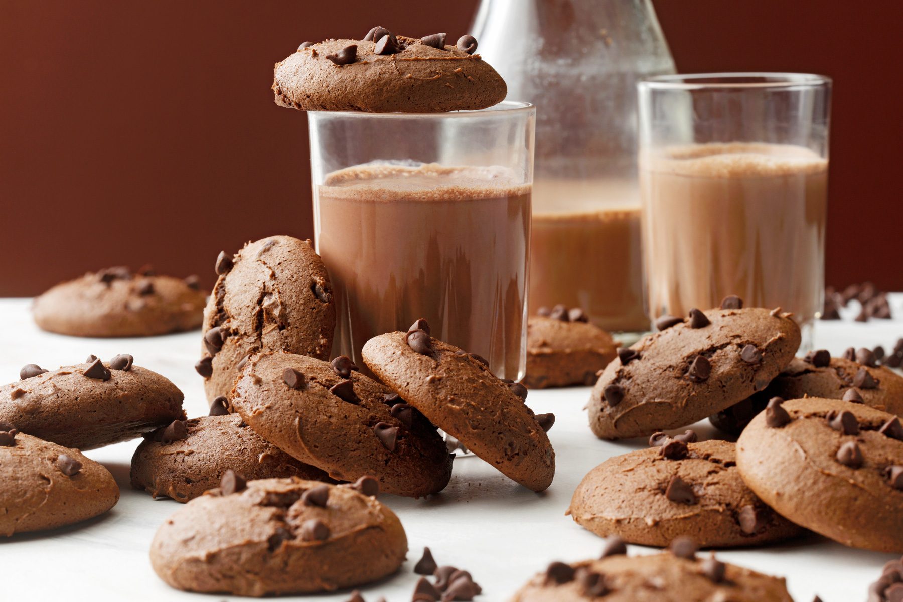 Devil's Food Cookies eye level shot with chocolate milk in glasses