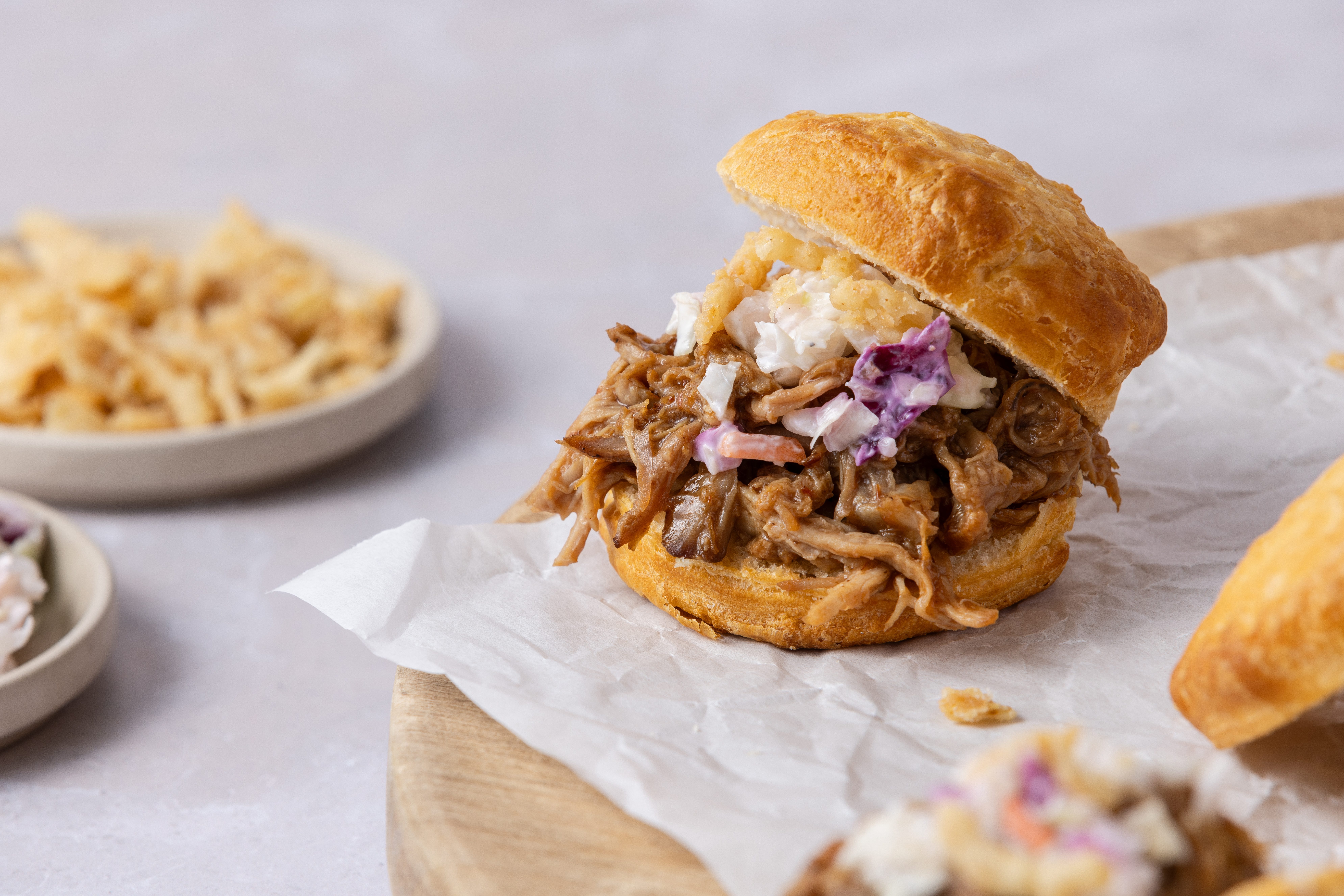 Pulled pork served on biscuits with colewslaw and french fried onions.