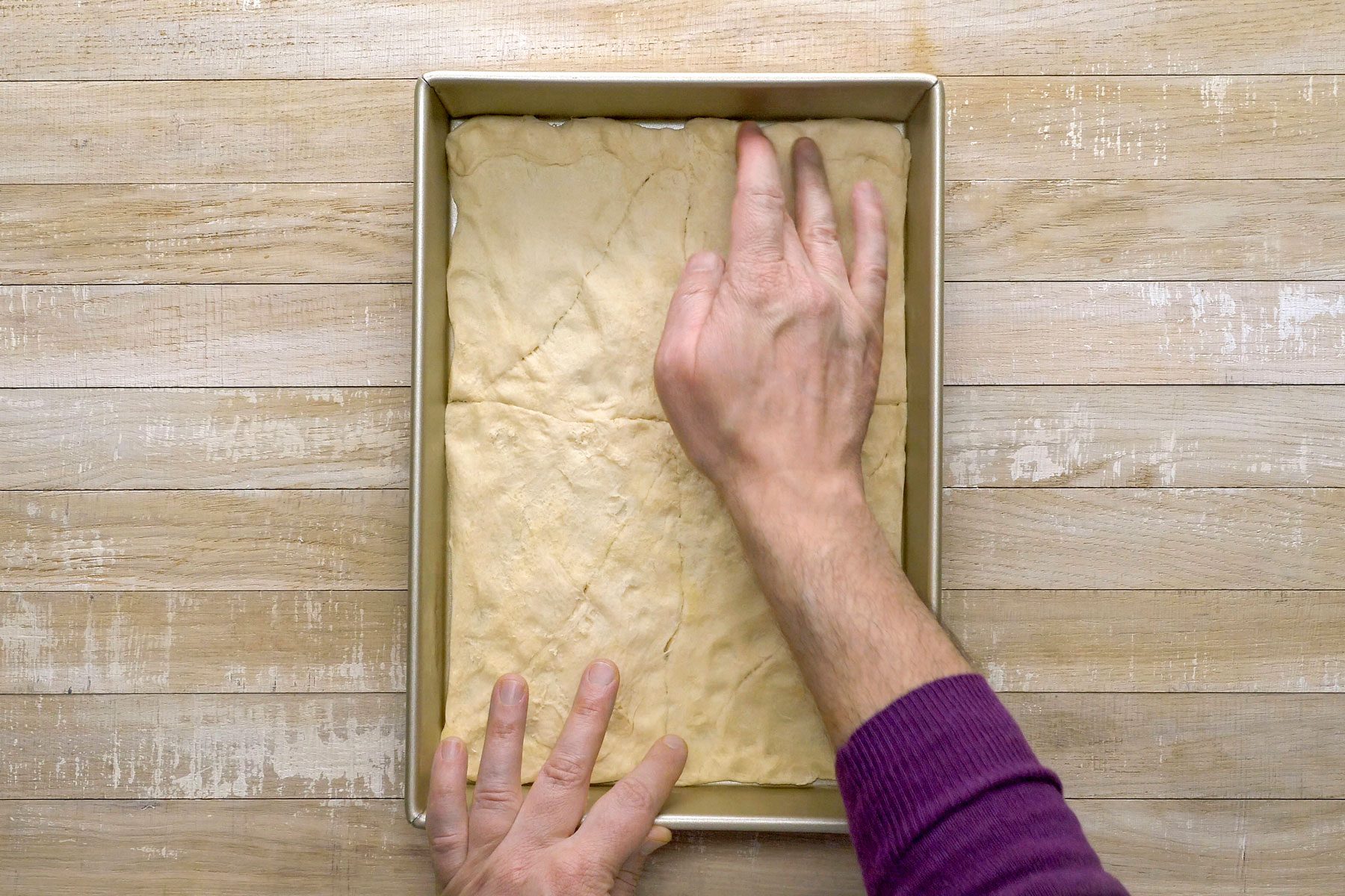 Dough rolled in the shape of a rectangle pressed onto the bottom of a baking pan.