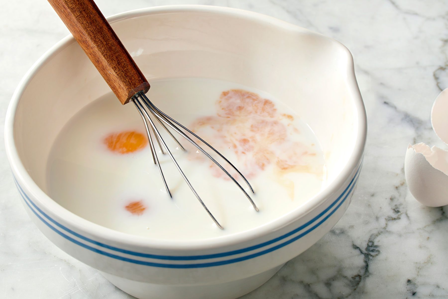 eggs, milk and vanilla mixed in a bowl.