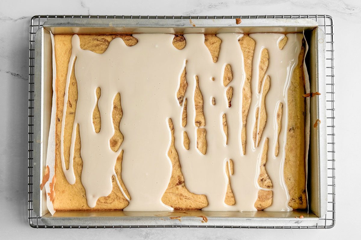 Taste of Home Honey Bun Cake on a wire rack on a marble surface