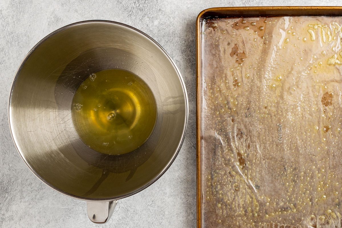 Taste of Home Jelly Roll recipe photo of the egg whites in a mixing bowl and the baking pan with wax paper.