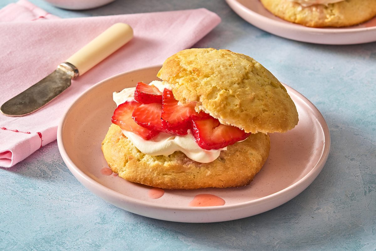 Closeup shot of a lemon strawberry shortcake filled with marinated strawberries, sweet cream and lemon butter