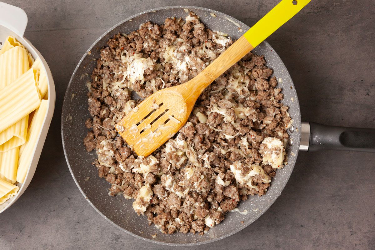 Step 3 of Taste of Home Meaty Manicotti is to stir the mozzarella cheese, cream cheese and salt into the meat mixture.