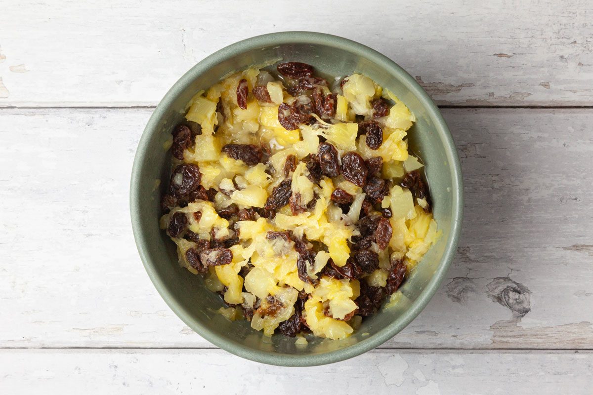 Step 1 of Taste of Home Jam Cake is to open the can of crushed pineapple. Pour it into a small bowl with the raisins, and let them stand together for at least 30 minutes.