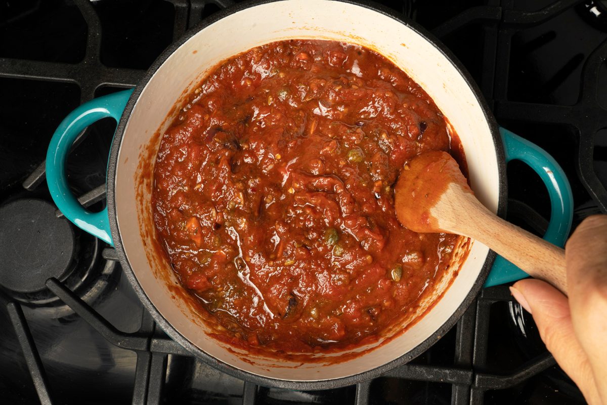 Adding tomato sauce to the Puttanesca mix