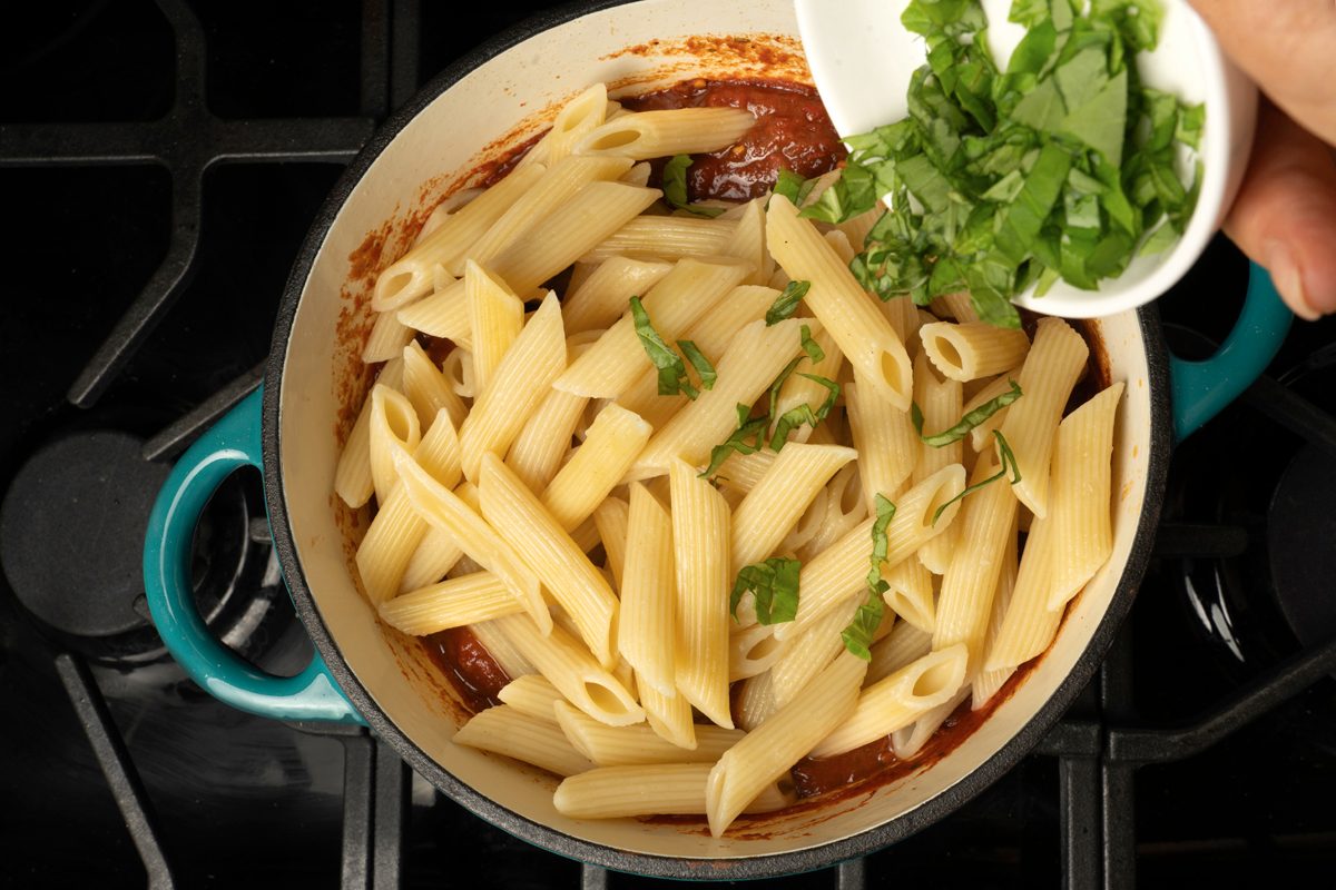Adding fresh Basil to the pasta