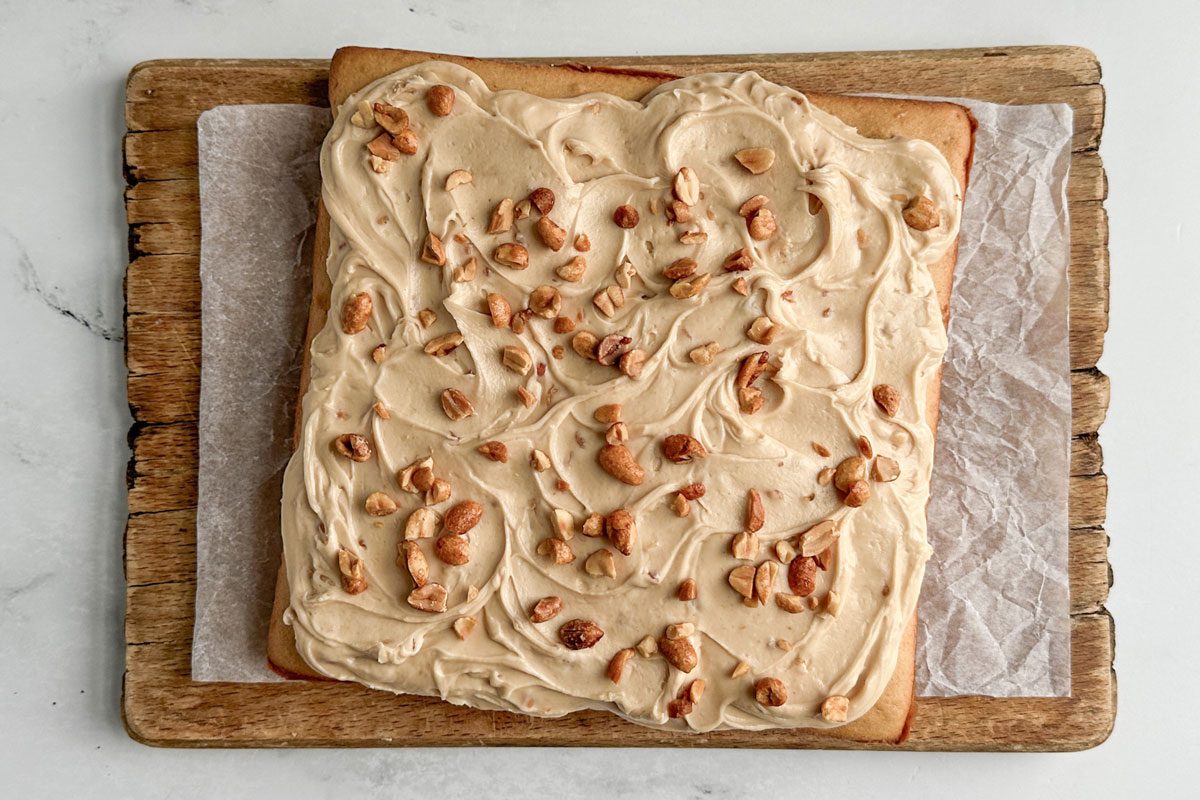 Taste of Home Peanut Butter Cake on wooden board on a marble surface