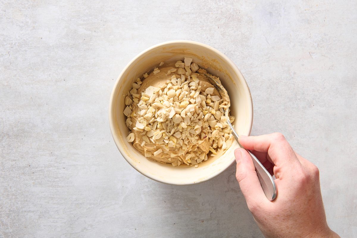 Stirring in the chopped peanuts