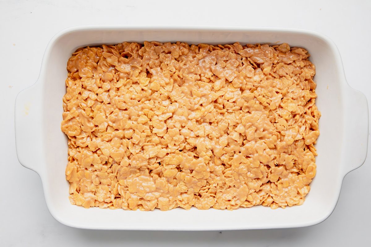 Overhead shot for Taste of Home Peanut Butter Cornflake Cookies mixture setting in a pan.