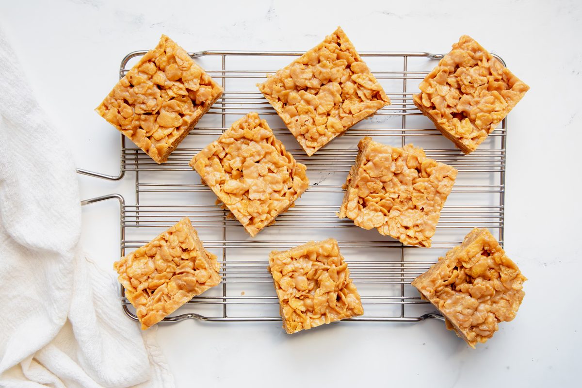Overhead beauty shot for Taste of Home Peanut Butter Cornflake Cookies cut on a wire rack.