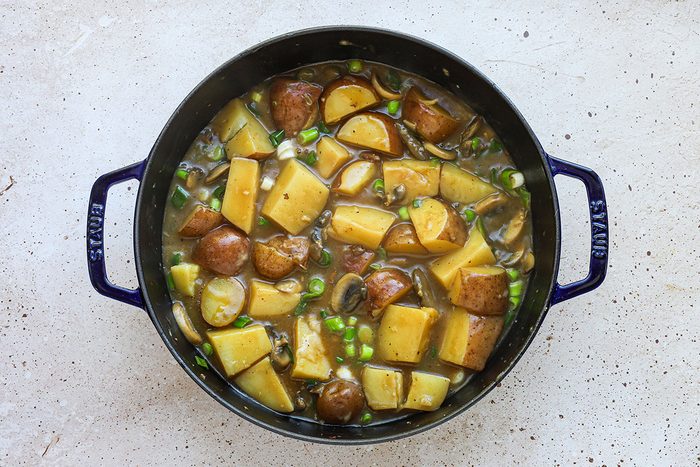 Pork and potatoes skillet dish preparation, a recipe from Taste of Home.