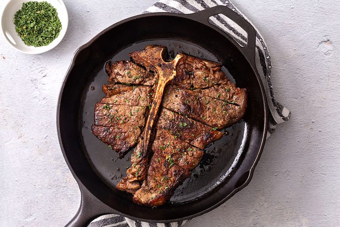 Cut porterhouse steak in a cast iron skillet for Taste of Home