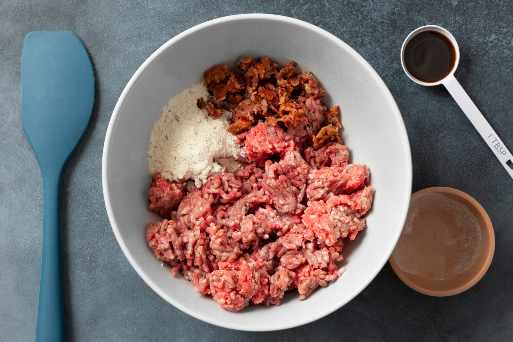 In a large bowl, combine ground beef, ranch mix, bacon and Worcestershire; mix lightly but thoroughly