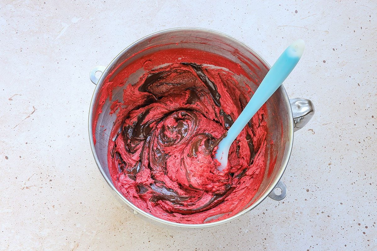 Melted chocolate is added to the red velvet whoopie pie batter, a recipe from Taste of Home.