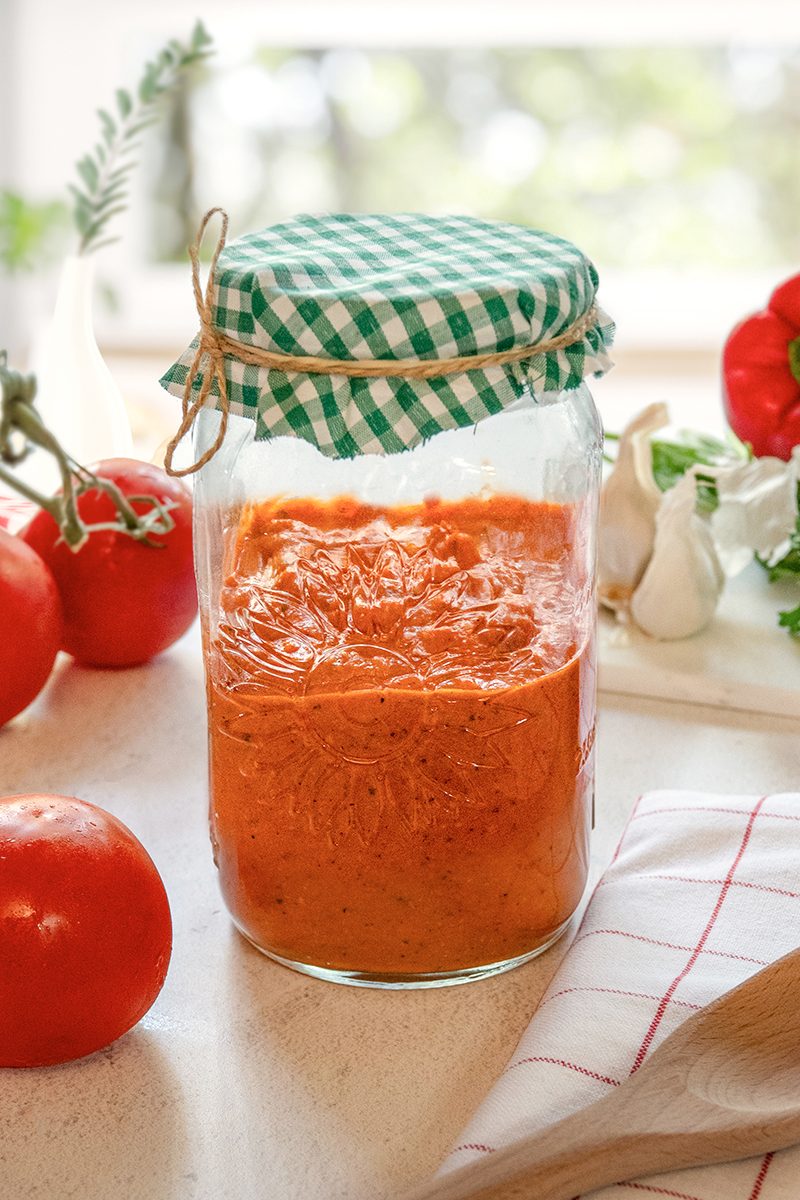 Romesco Sauce is kept in a jar, ready to use on meats, fish, veggies, and more.