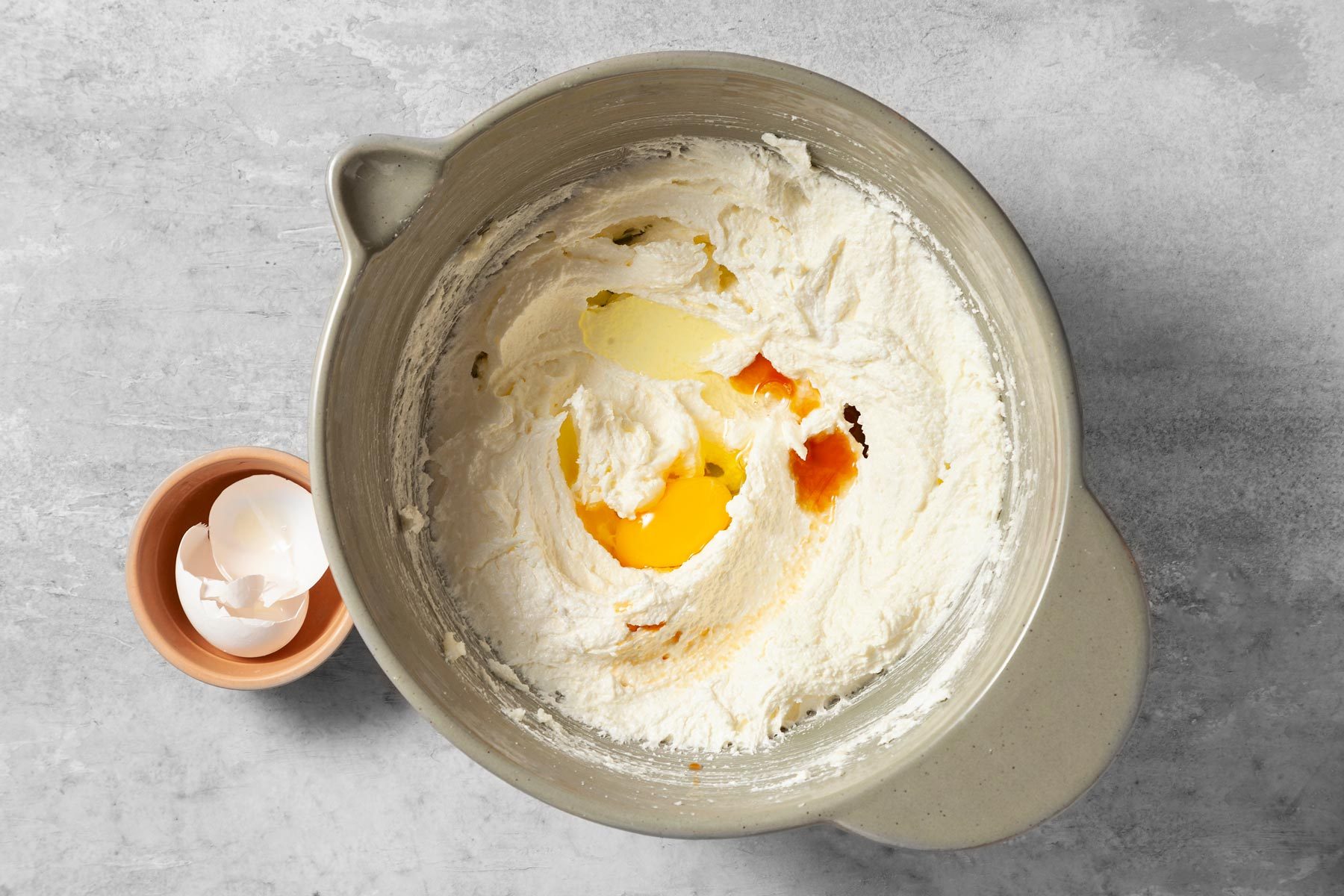 Add egg and extracts in the creamy mixture