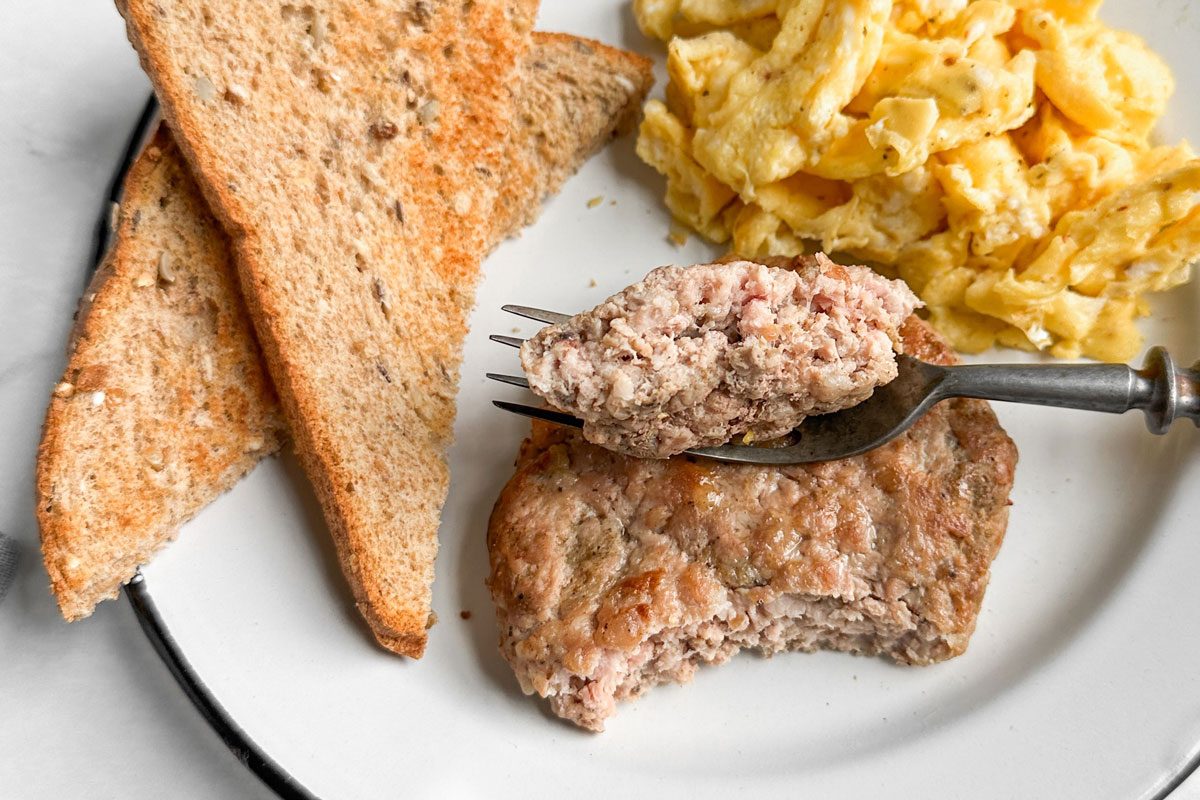 Taste of Home Sausage Patties on an enamel plate with toast and scrambled eggs