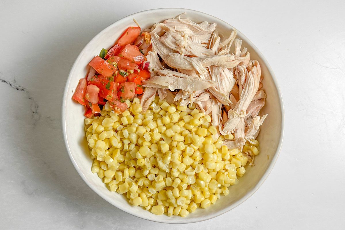 Ingredients for Taste of Home Shredded Chicken Tacos in a ceramic bowl