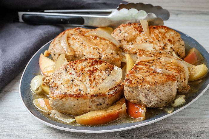 A platter of boneless pork chops cooked with apples and onions, from Taste of Home.
