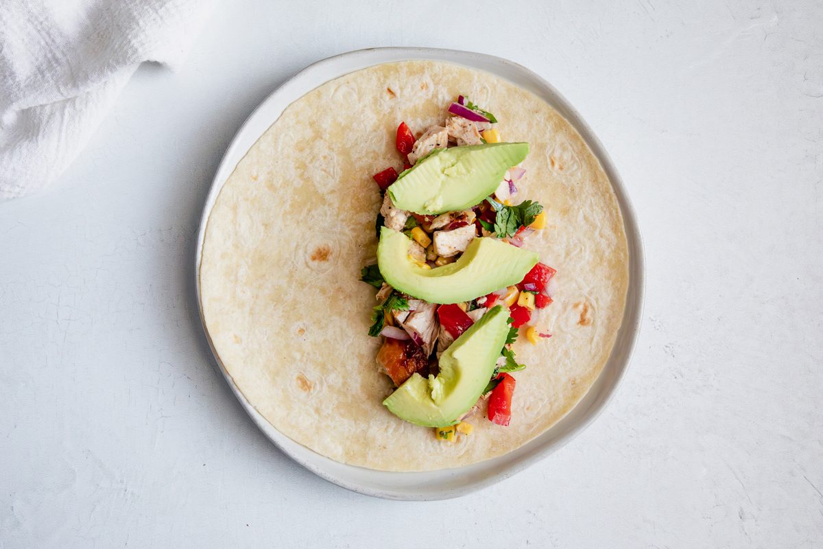 Overhead shot for Taste of Home Southwest Chicken Salad on a wrap with avocado.