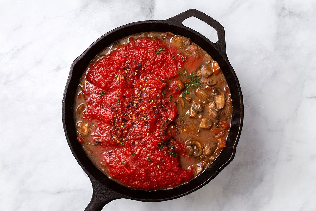 White wine, beef broth, tomatoes, salt, oregano, sugar and crushed red pepper flakes. mixed in large skillet for the sauce for step four of Steak Pizzaiola recipe for Taste of Home