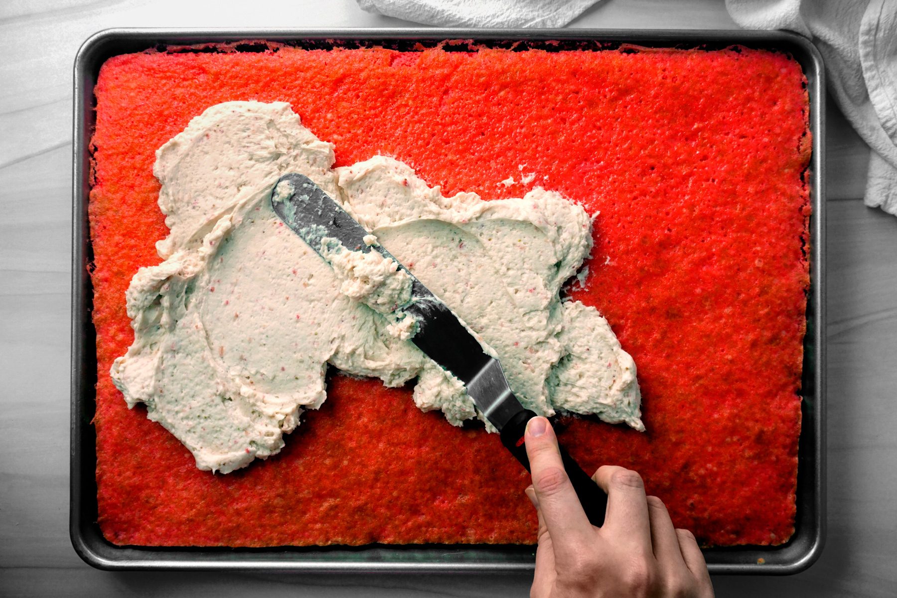 Spread frosting on top of the cake