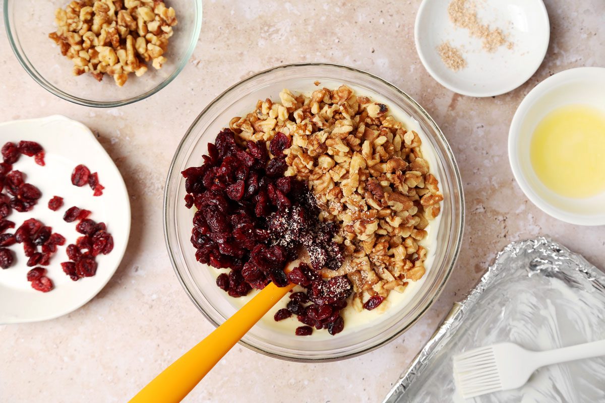 Process shot of the making of Taste of Home's White Chocolate Bark in a mixing bowl on a beige surface