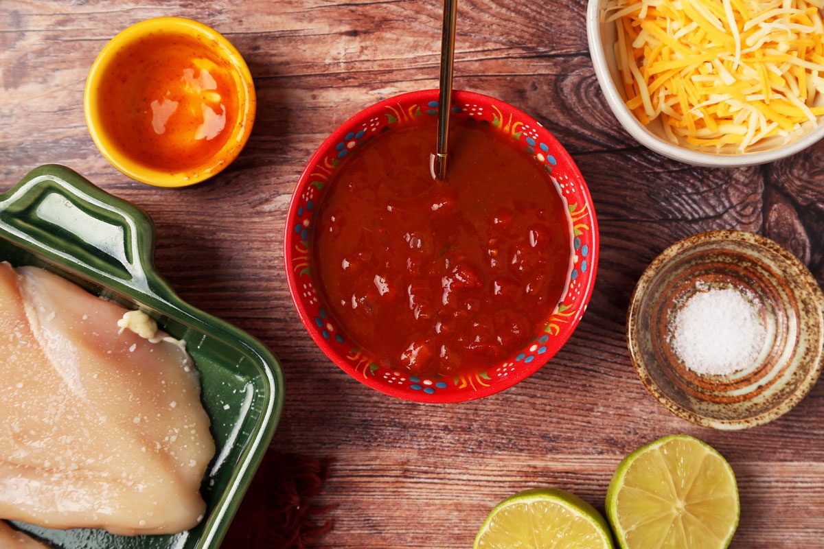 Process of making Taste of Home's Salsa Chicken in a green baking dish on a wooden surface.