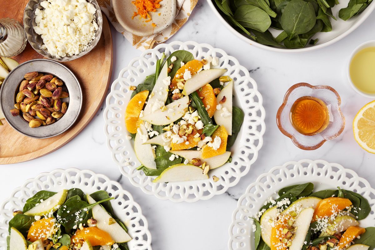 Process of how to make Taste of Home's Pear Salad on a white marble surface with a yellow linen.