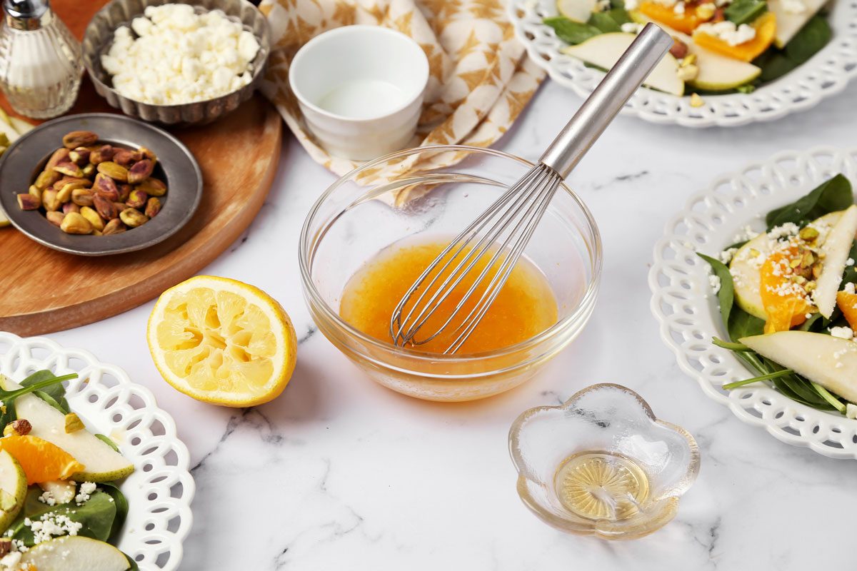 Process of how to make Taste of Home's Pear Salad on a white marble surface with a yellow linen.