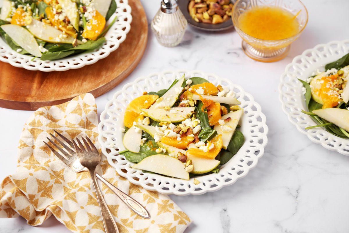 Close up of Taste of Home's Pear Salad on a white marble surface with a yellow linen.
