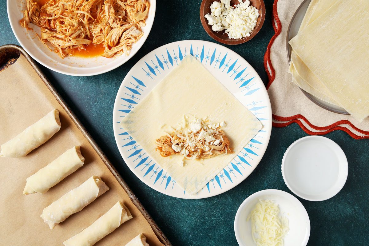 Process of making Taste of Home's Buffalo Chicken Egg Rolls. Chicken filling on an egg roll wrapper.
