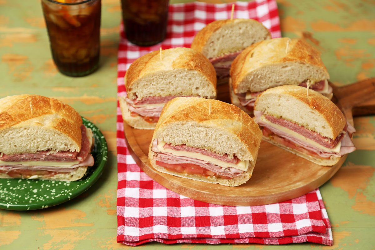 Close up of Taste of Home's Italian Sub on a wooden board with a red gingham towel.