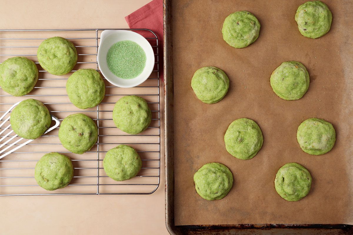 The process of making Taste of Home's Pistachio Cookies on a baking sheet with cookie dough in a large bowl.