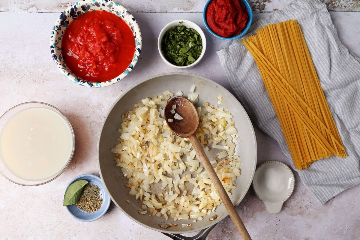 Cooking Taste of Home's Red Clam Sauce in a slow cooker on a grey background.