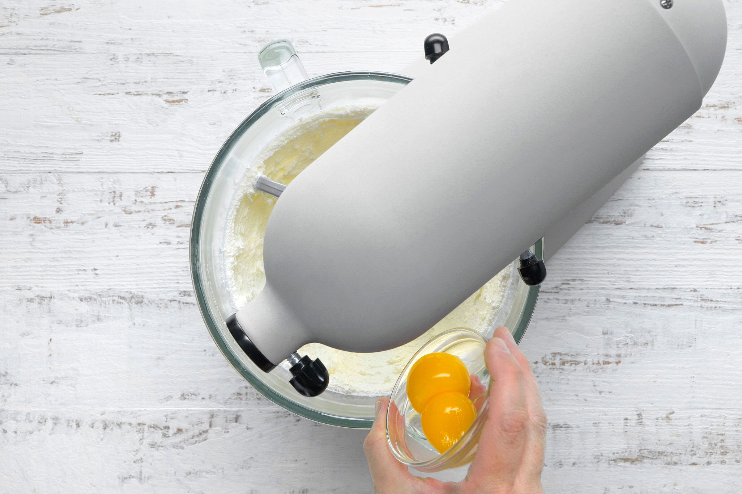 Beating in the egg yolks on low speed to make cookie dough