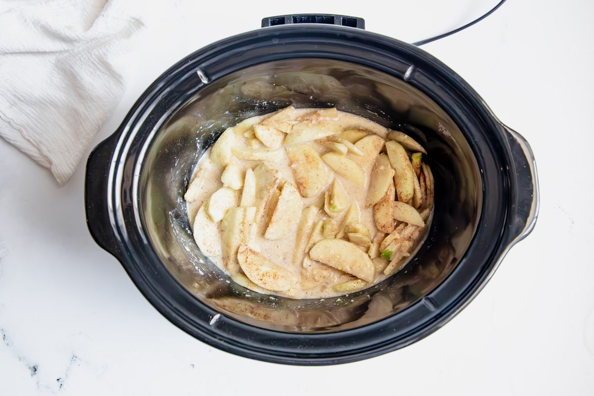 Overhead shot for Taste of Home Apple Streusel with apples and spices in a slow cooker.