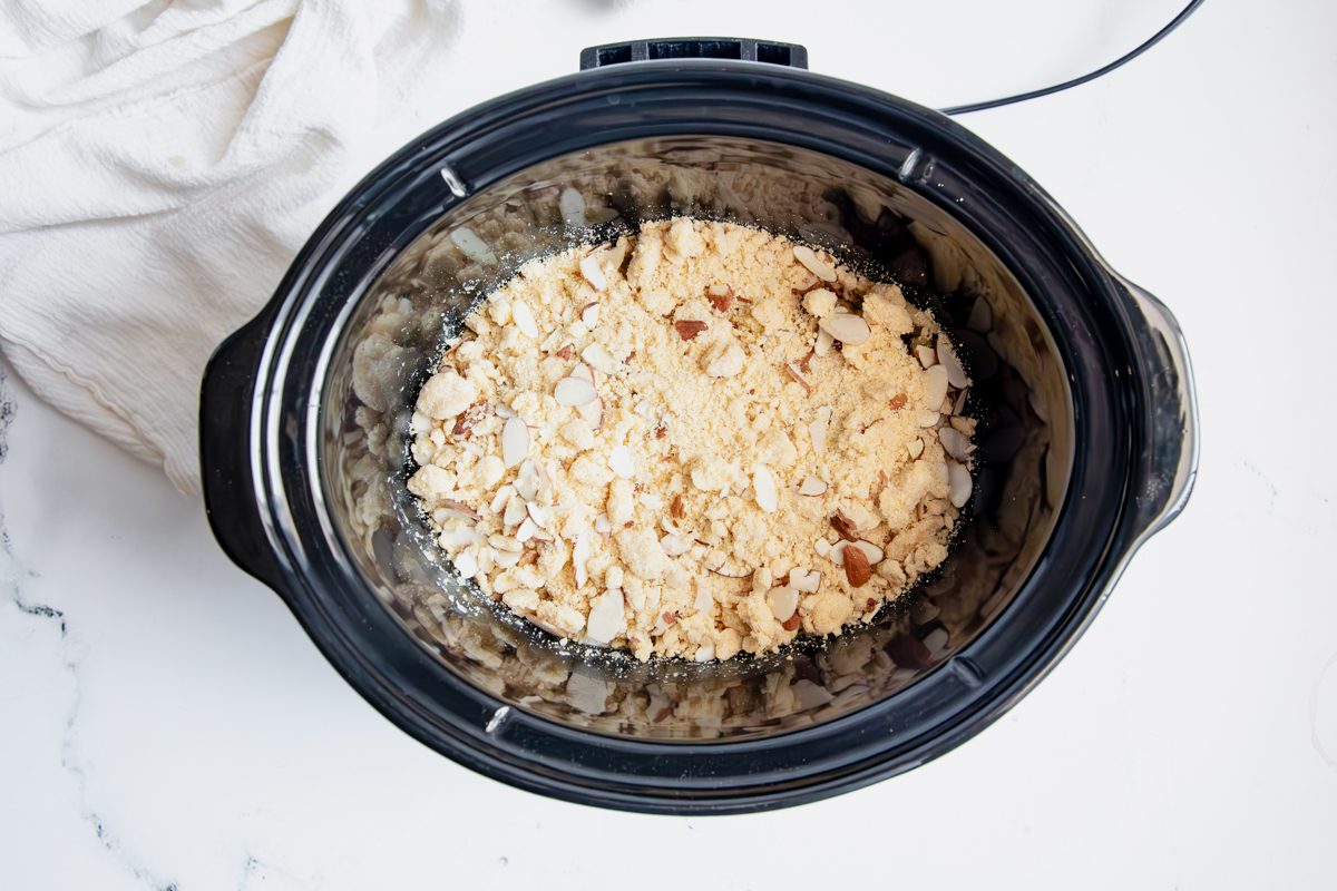 Overhead shot for Taste of Home Apple Streusel, apples topped with streusel mixture in a slow cooker