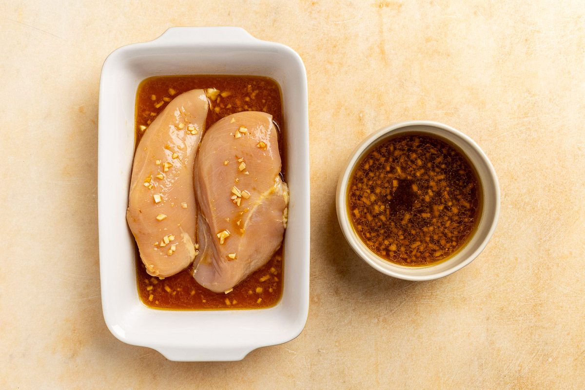 chicken in the marinade with reserved dressing on the side.