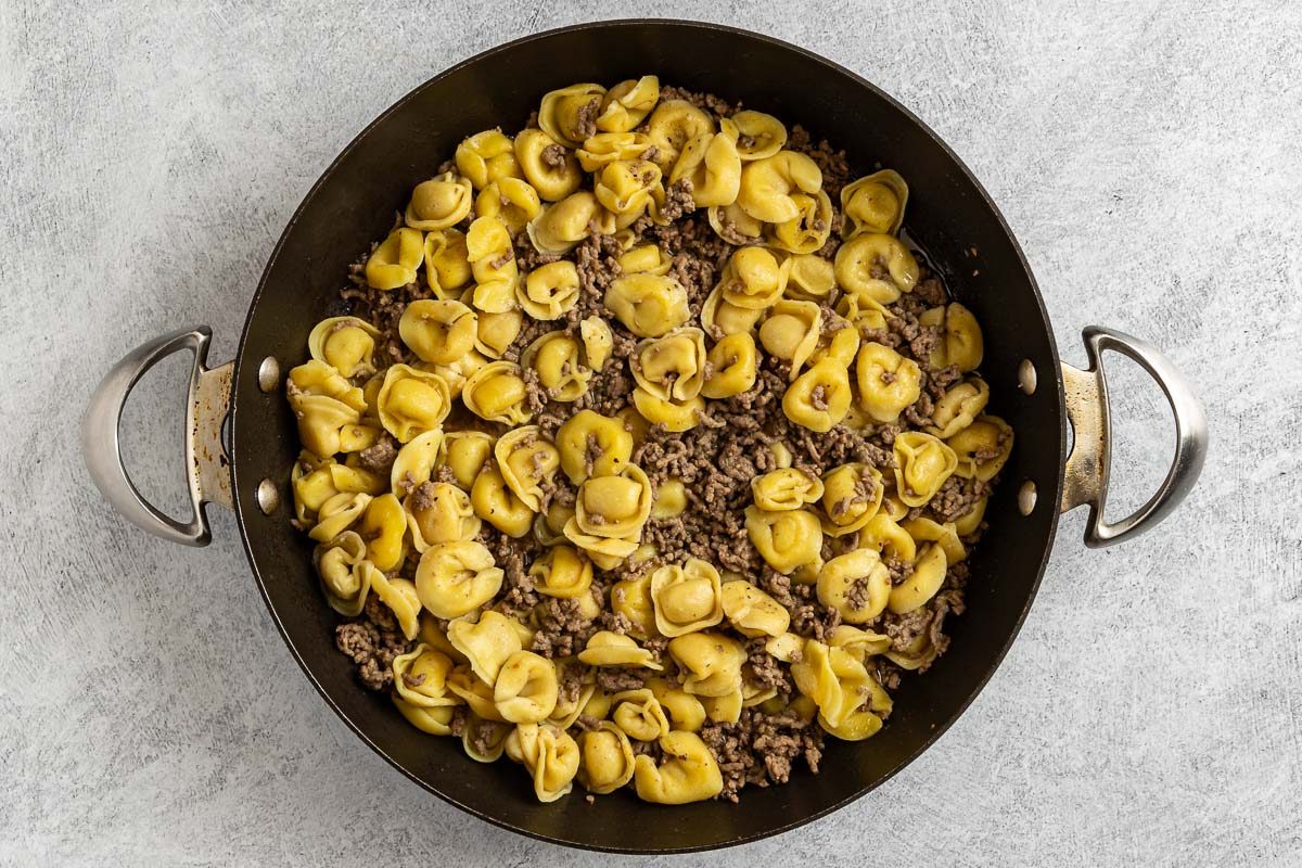 Taste of Home Beef Tortellini photo of the cooked tortellini in the skillet with the ground beef.
