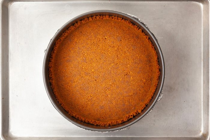 Step 1 of Taste of Home Biscoff Cheesecake is to prepare the crust