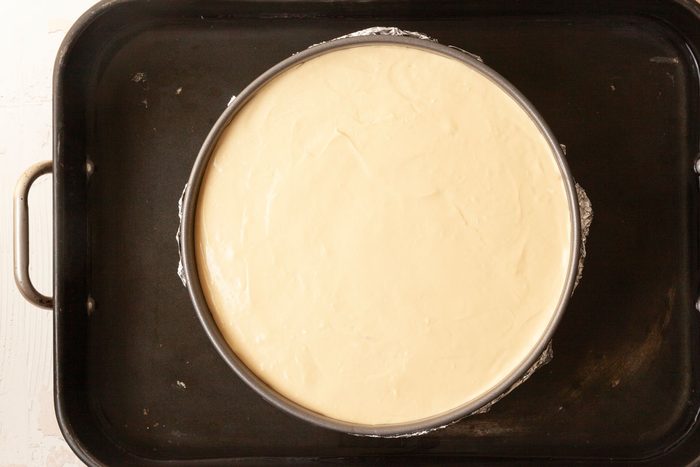 Step 3 of Taste of Home Biscoff Cheesecake is to bake the cheesecake and then top with melted cookie butter