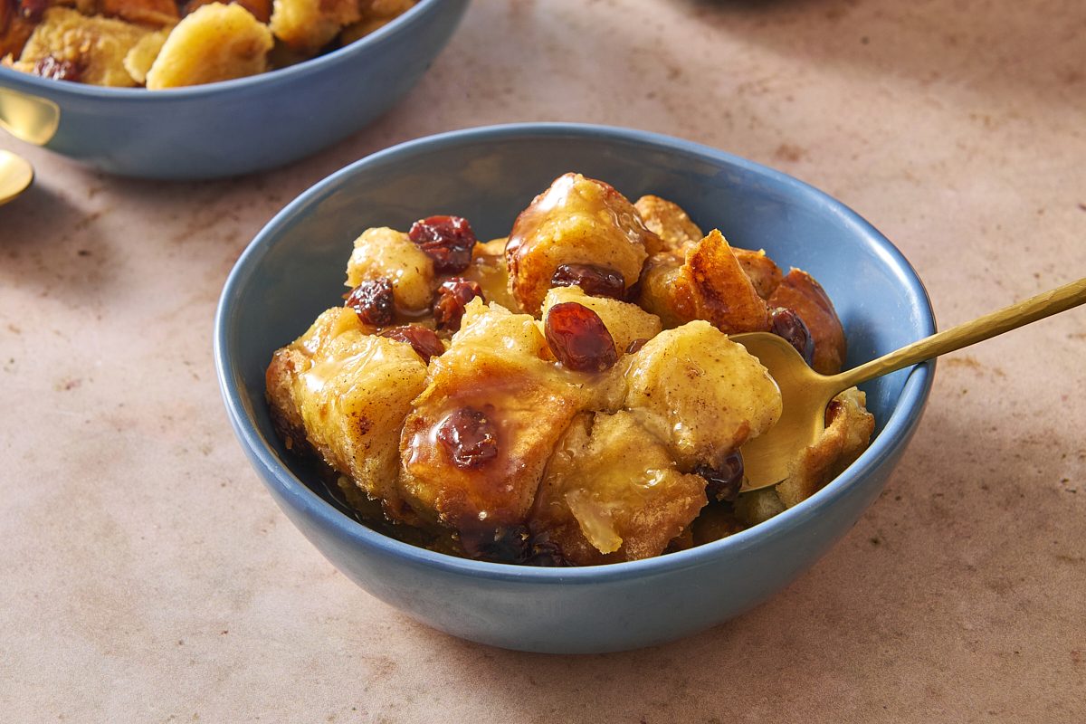 Closeup shot of a bowl of bread pudding with bourbon sauce