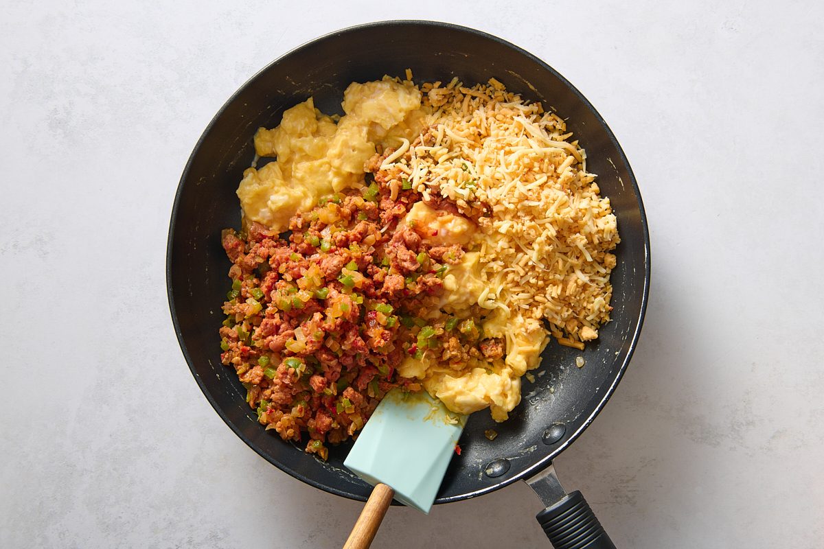 Mixing the chorizo and cheese into the scrambled eggs