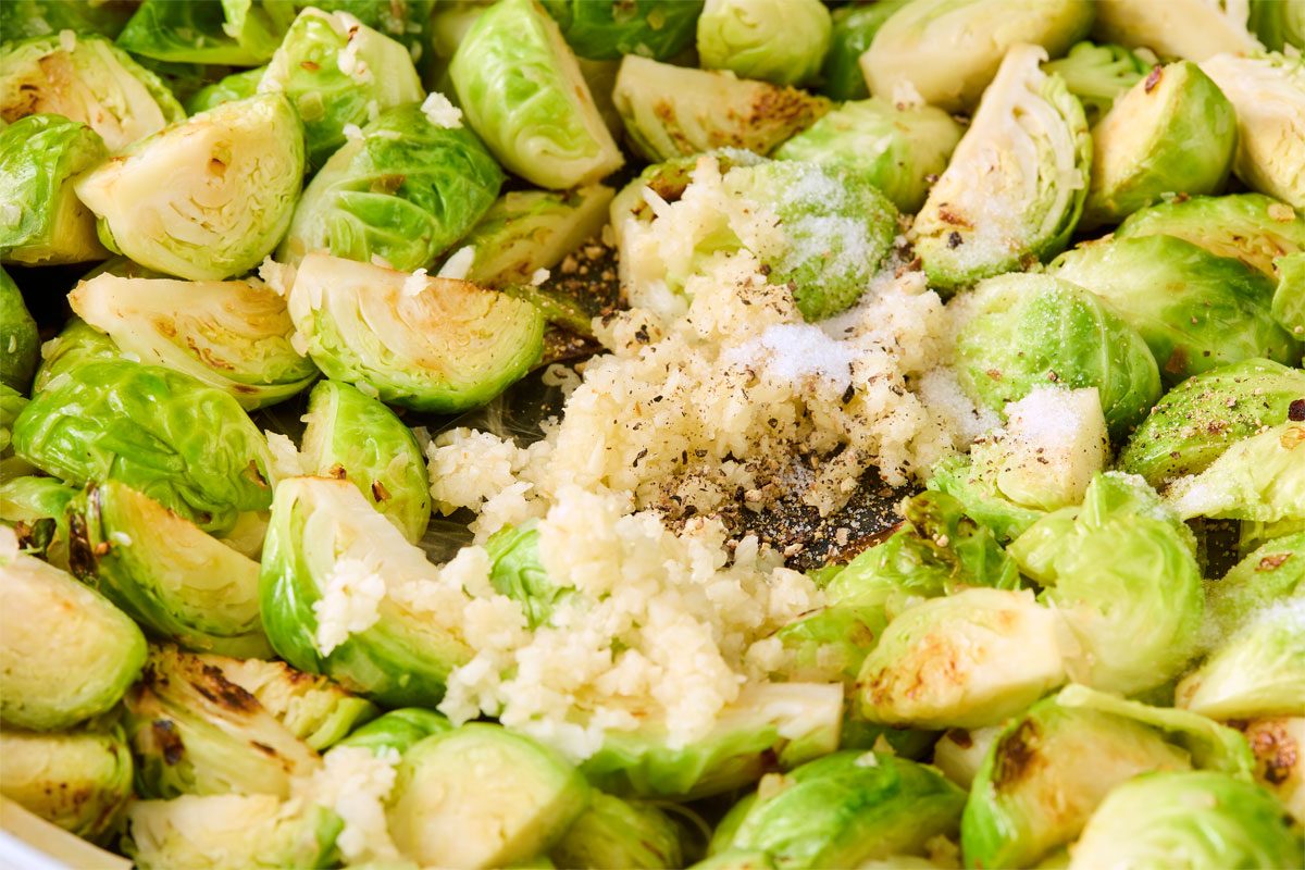 Close shot of stir in garlic; 1/2 teaspoon salt and 1/4 teaspoon pepper; cook one minute longer;