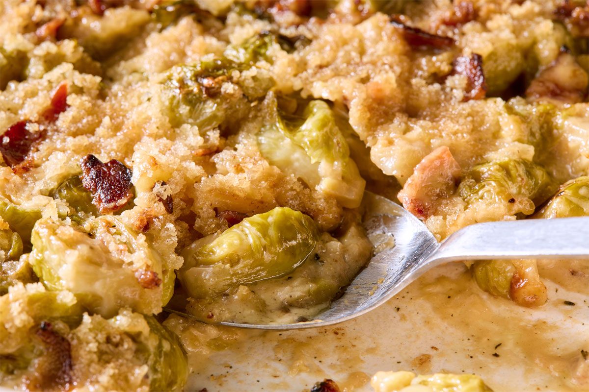Close Shot Of Brussels Sprouts Casserole; In A Baking Pan; Serving Spoon;