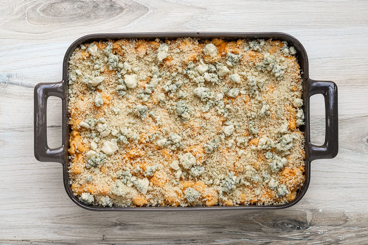 Topping the Buffalo chicken mac and cheese with panko and blue cheese crumbles.
