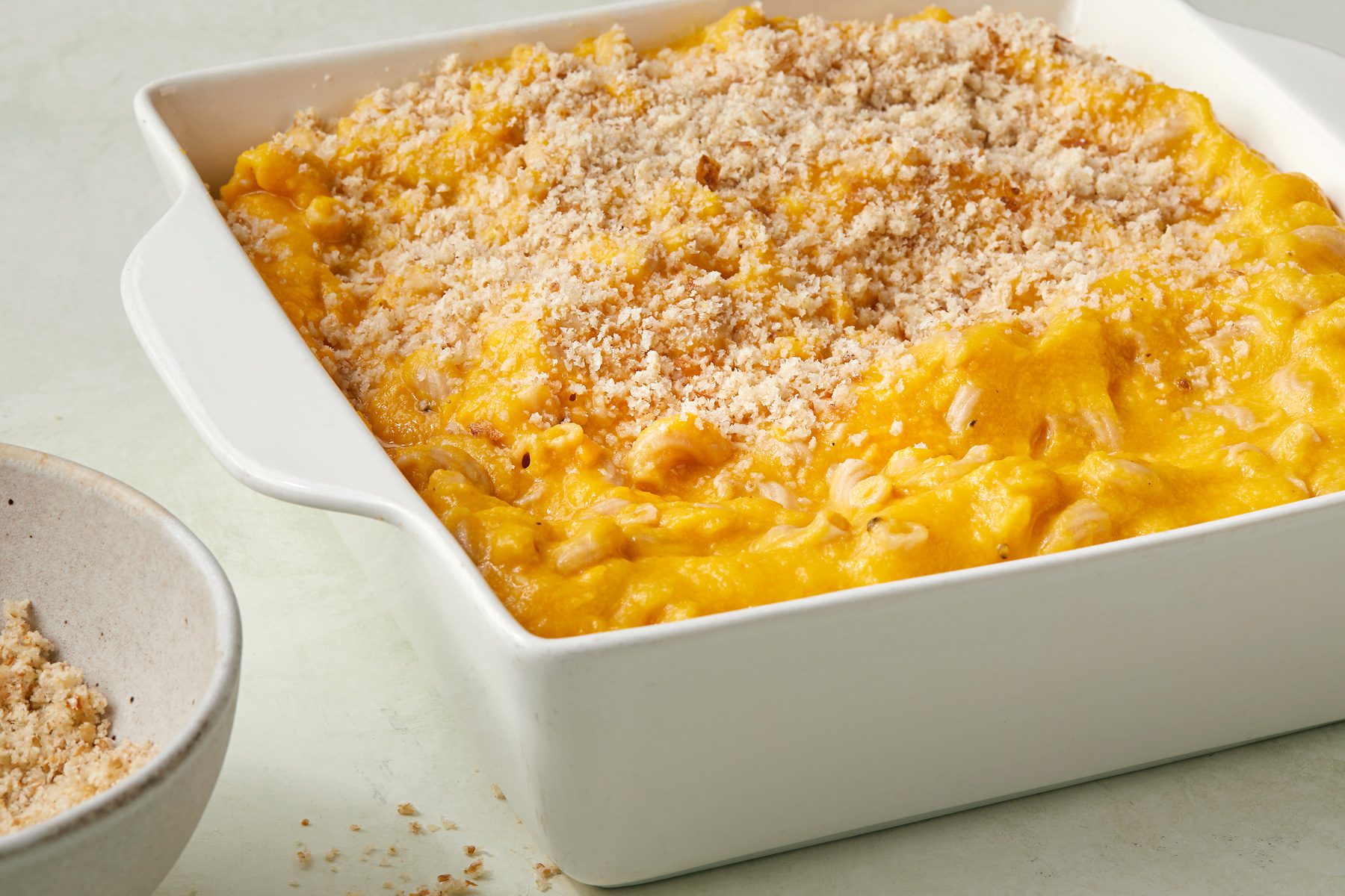 Transfer to a greased 8 inch square baking dish; Sprinkle with bread crumbs